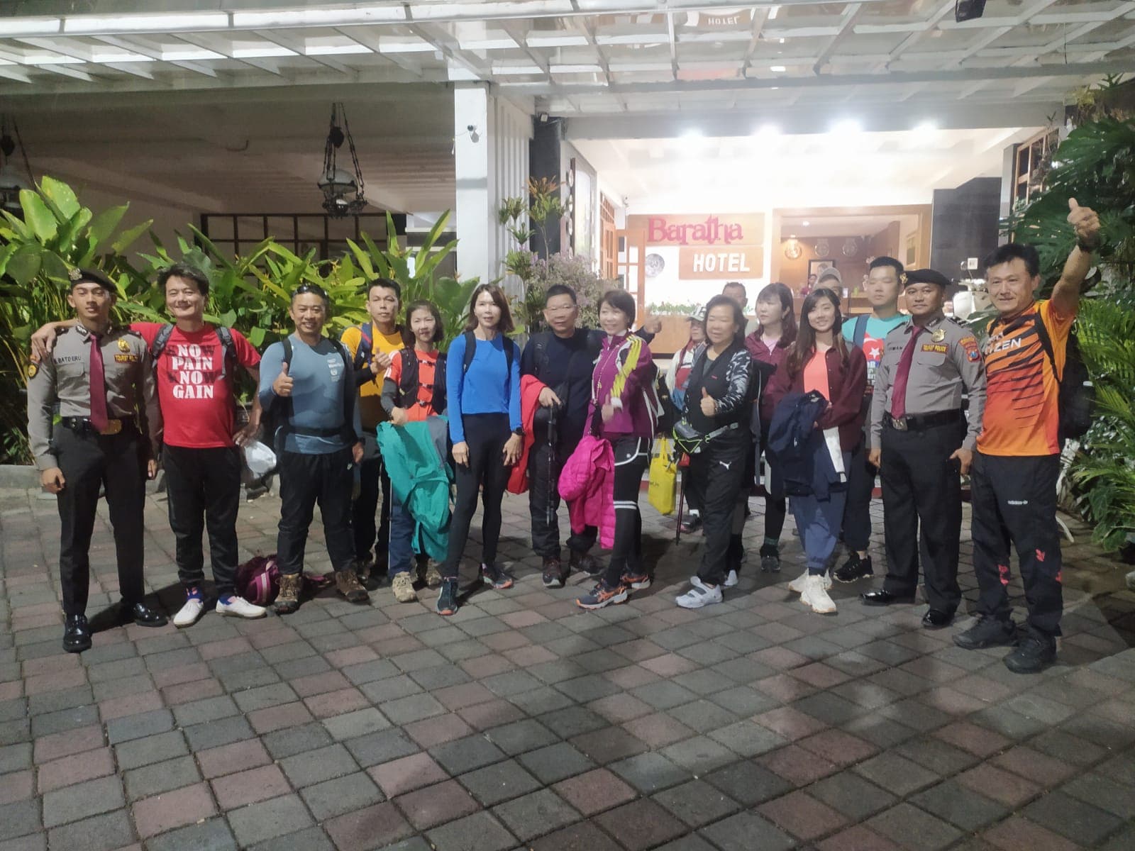 Team and guests lined up outside Baratha Hotel before Ijen ascent with Tourist Police support vehicle